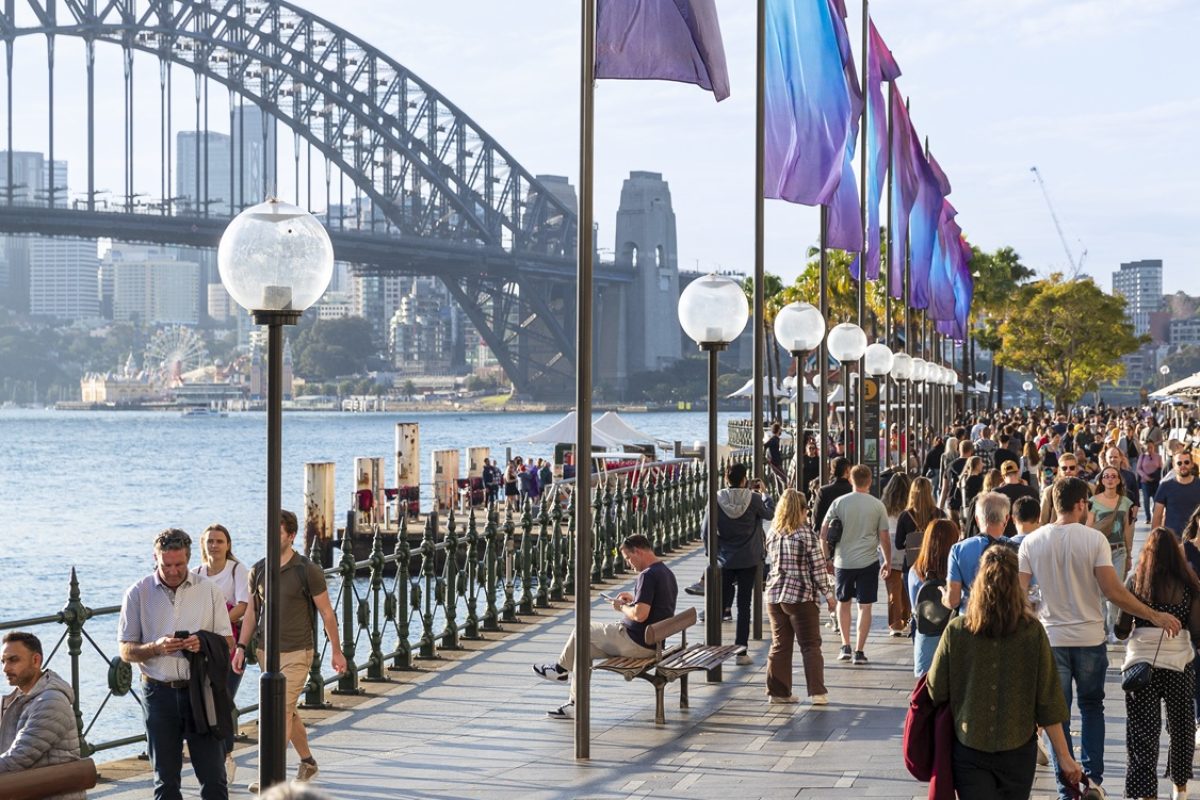 Crowd of people at Circular Quay at Sydney Harbour, with the Sydney Harbour Bridge.